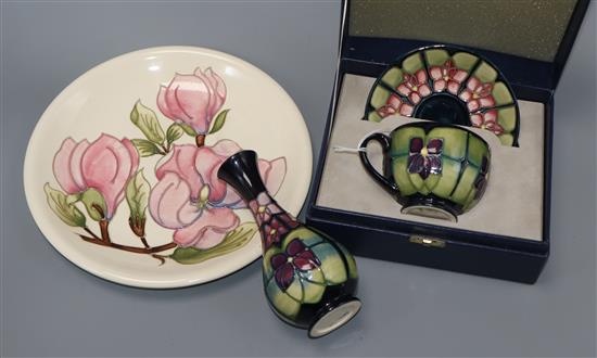 A Moorcroft vase, a plate and cased teacup and saucer